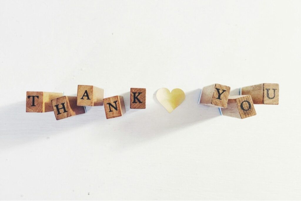 Wooden blocks spelling “Thank You,” symbolizing how free shipping strengthens customer loyalty and brand reputation in online retail.