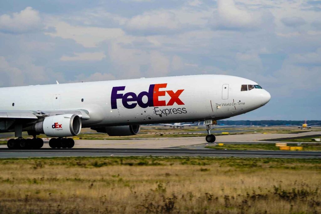 FedEx Express cargo airplane taxiing on an airport runway, representing global logistics and international delivery in the USPS vs FedEx comparison — highlighting the difference between FedEx International Economy and USPS Priority Mail International shipping speed and reliability.